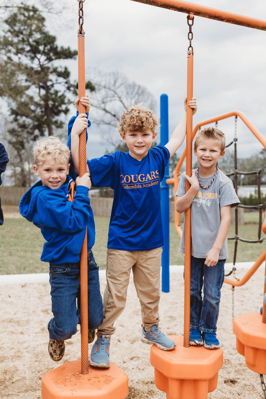 Young Columbia Academy students on the campus playground